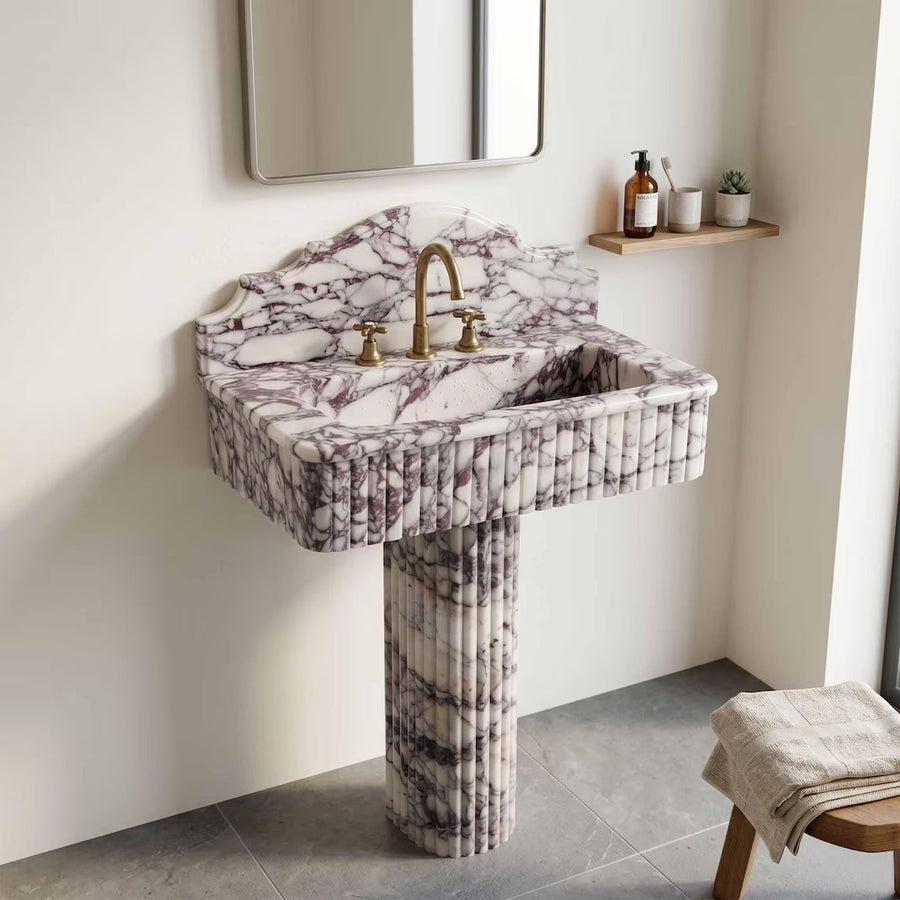 Calacatta viola marble sink with pedestal in a bathroom