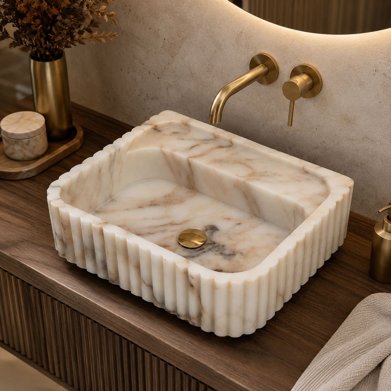 Top view of Calacatta Gold marble sink with scalloped fluted edge and brass faucet