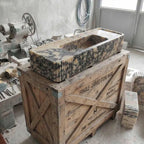 Marble sink on a wooden crate in a workshop setting