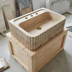 Marble sink on a wooden stand with tiles in the background