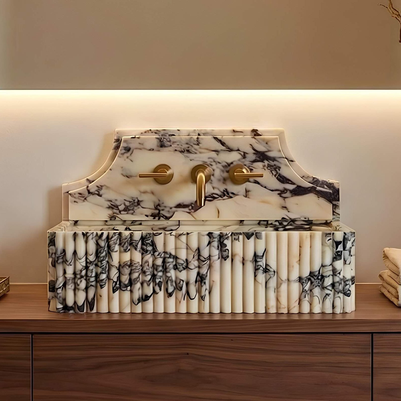 Marble-patterned vanity with gold fixtures on a wooden surface.