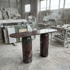 Marble table with cylindrical legs in a workshop setting