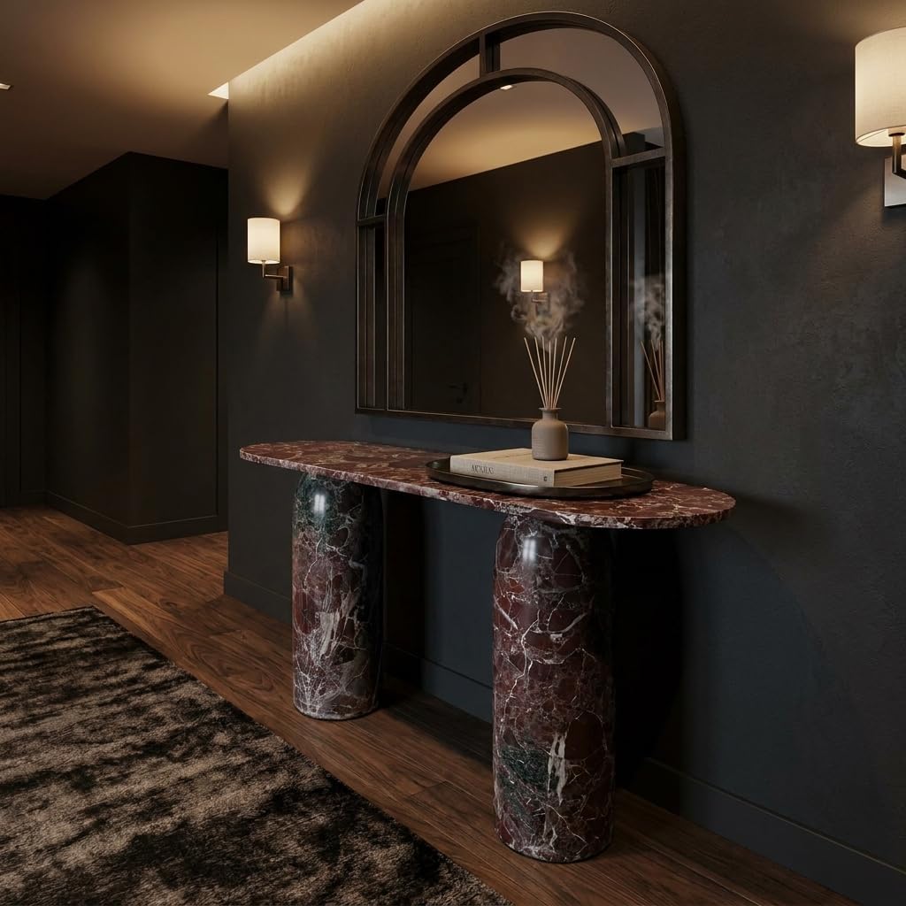 Marble console table against a dark wall with a mirror above it.