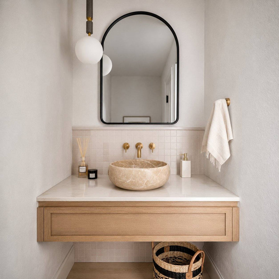 Bathroom vanity with marble sink, mirror, and towel.