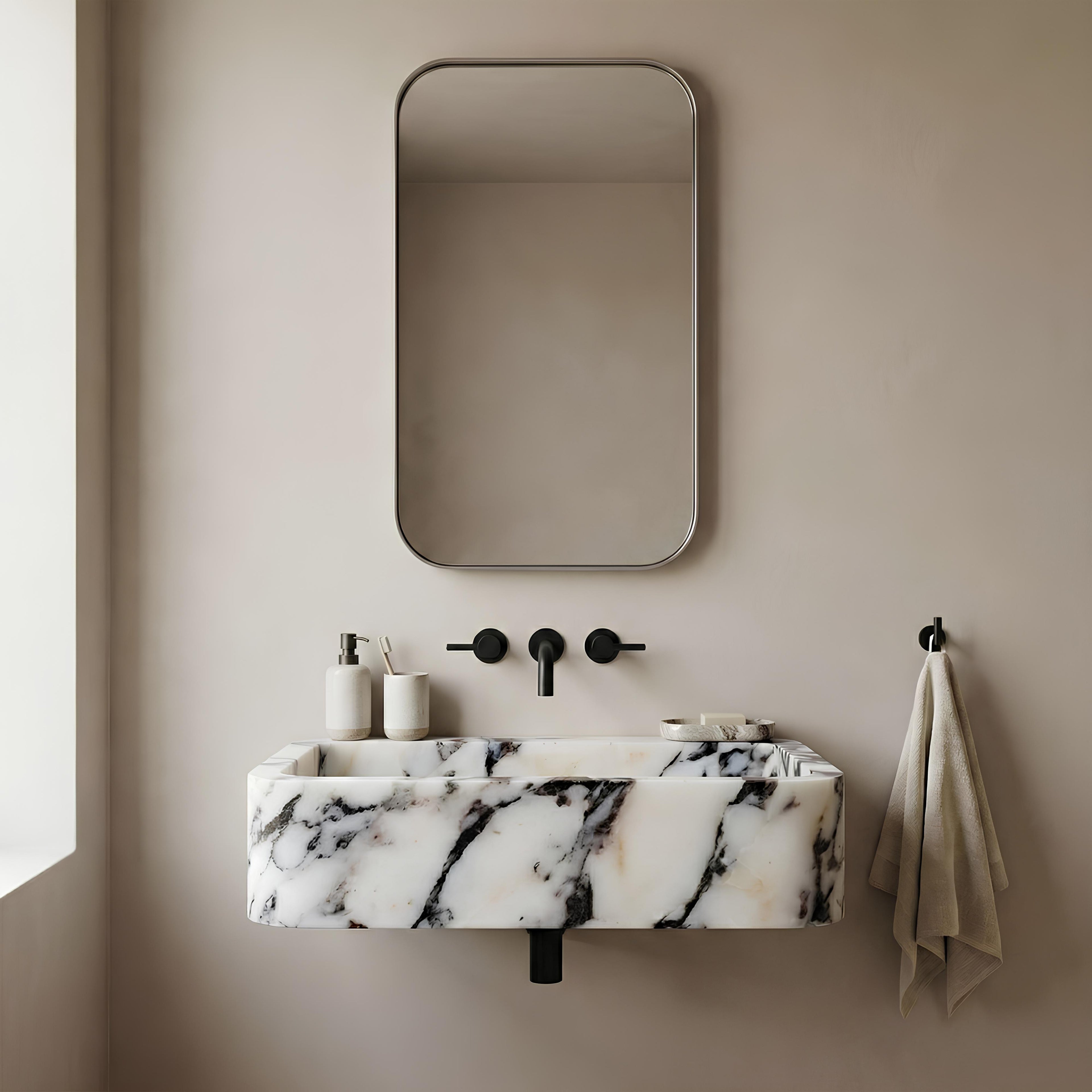 Bathroom with marble sink, mirror, and towel on beige wall